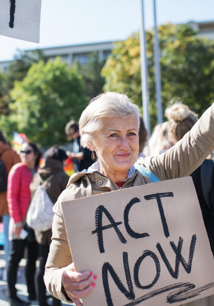 senior-with-placard-and-poster-on-global-strike-for-climate-change-picture-id1181043861